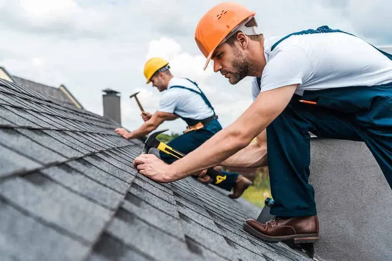 Calgary roofing crew installing shingles on a roof