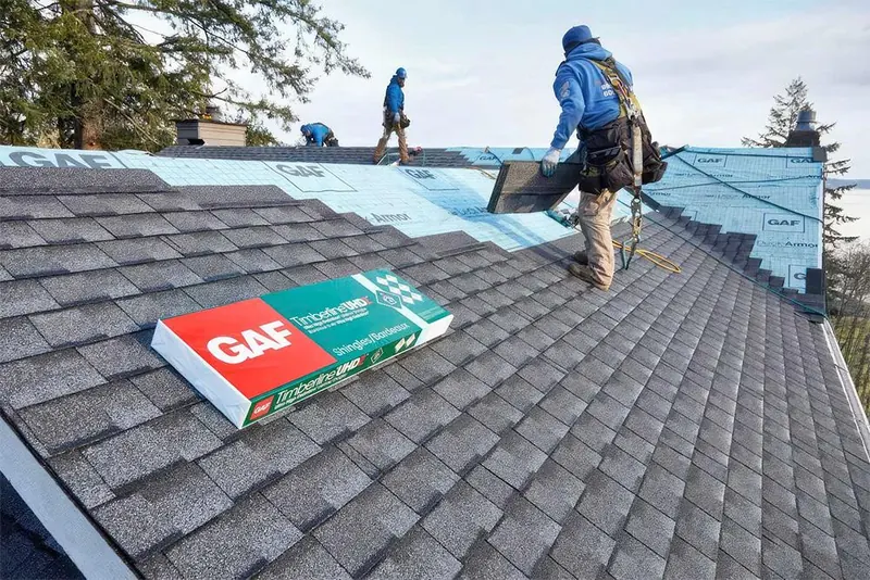Freshly installed architectural shingles on a completed roof